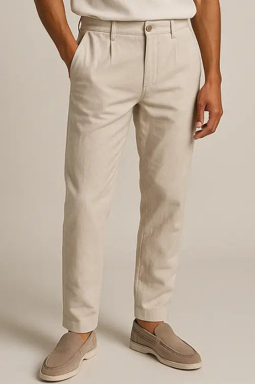 Close-up of a man wearing slim fit beige chino pants with side pockets and beige loafers, styled for a modern casual look.